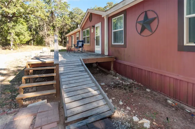 a view of a house with a wooden floor and a large window