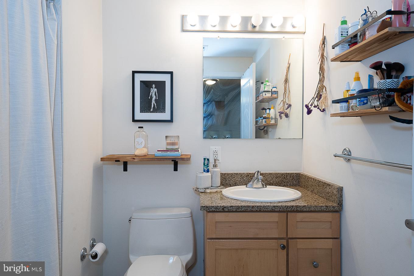 111 South 15th Street, Unit 2001 Philadelphia, PA 19102 - Photo 11 of 17 a bathroom with a toilet sink vanity and mirror