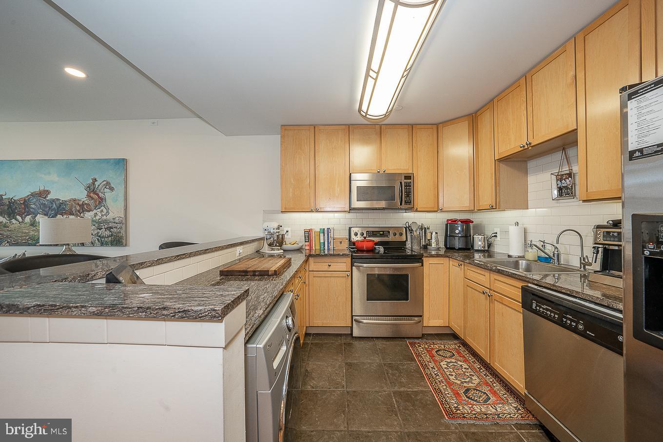 111 South 15th Street, Unit 2001 Philadelphia, PA 19102 - Photo 5 of 17 a kitchen with a sink a stove top oven and cabinetry
