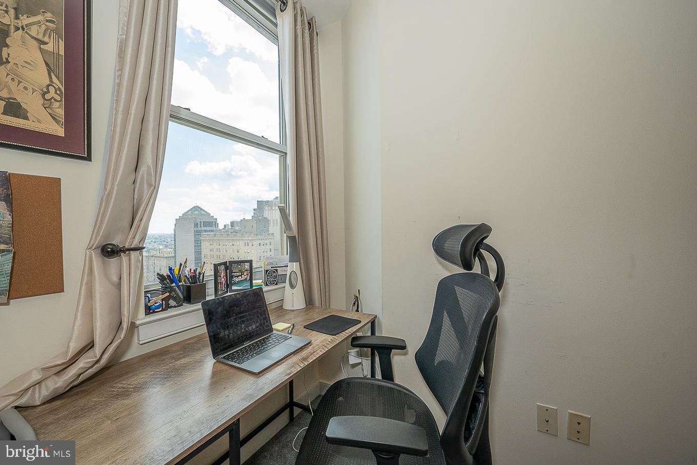 111 South 15th Street, Unit 2001 Philadelphia, PA 19102 - Photo 9 of 17 a view of a workspace with furniture and a window