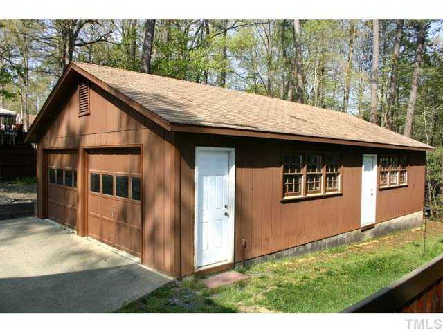 5026 Raintree Road Durham, NC 27712 - Photo 12 of 12 Huge 24 X 40 Garage/Shop can park 4 cars tandem, or handle 2 cars plus offer huge workshop or storage space. The inside is undivided with any interior walls. One door has an automatic overhead opener. Parking Lot/Garage