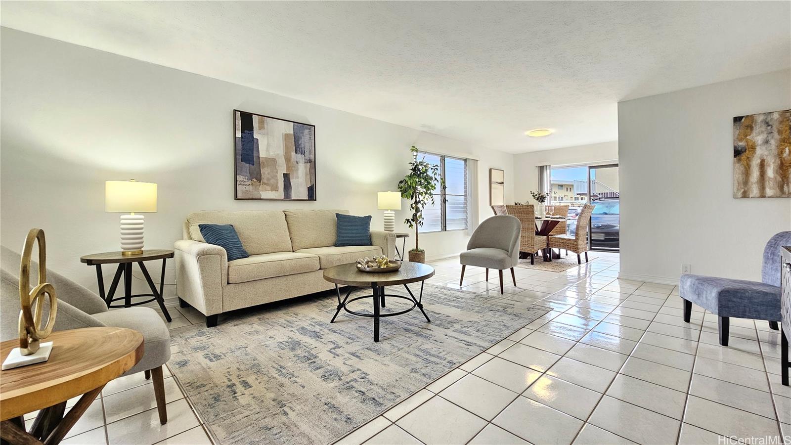 827 Ala Lilikoi Street, Unit 3239/1 Honolulu, HI 96818 - Photo 1 of 1 a living room with furniture and a dining table with rug kitchen