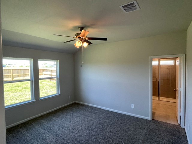1024 Legrand Street Brenham, TX 77833 - Photo 4 of 7 an empty room with windows and chandelier fan