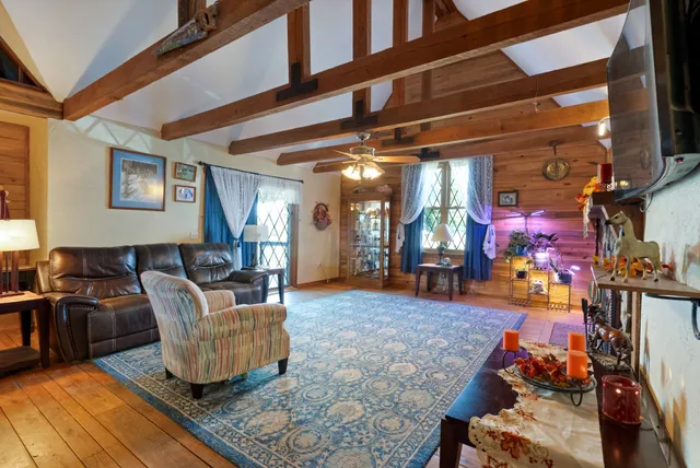 a living room with furniture a fireplace and a flat screen tv
