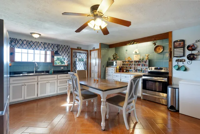 a dining table with chairs and wooden floor