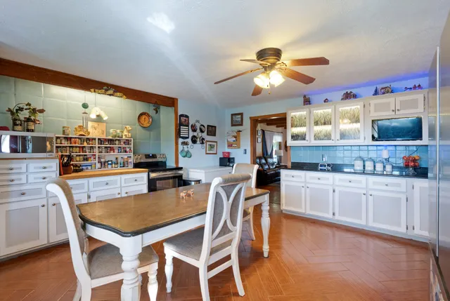 a kitchen with stainless steel appliances granite countertop a sink a stove and a wooden cabinets