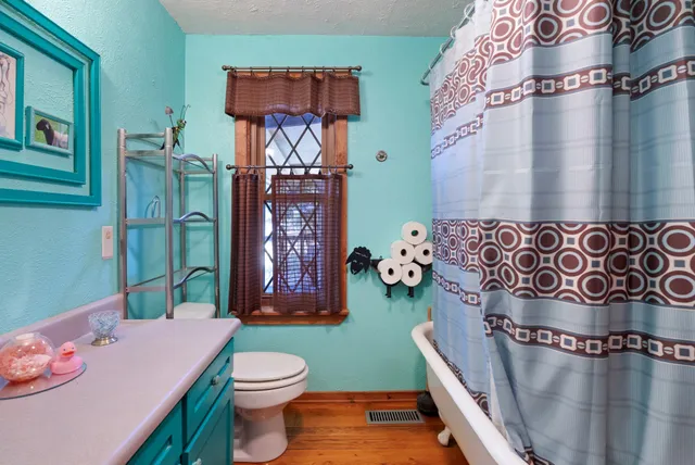 a view of living room kitchen with furniture and wooden floor