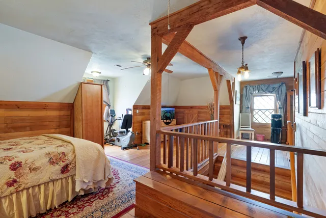 a bed sitting in a bedroom next to a window