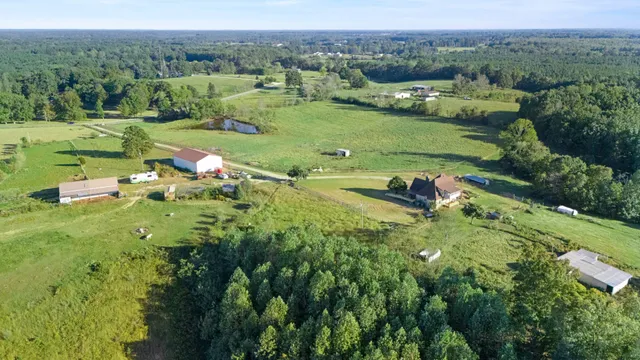 an aerial view of a house with a yard