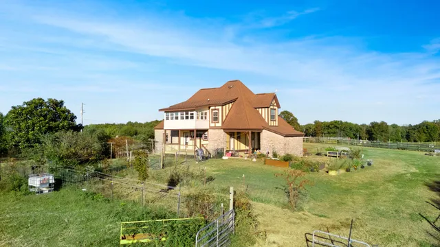 a front view of house with a garden