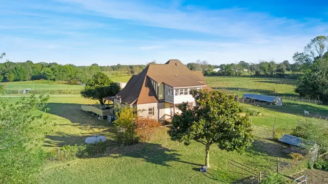 an aerial view of a house with a yard