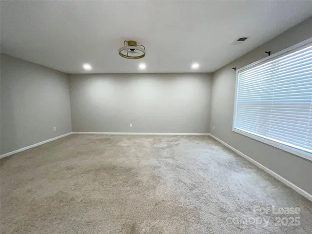 an empty room with a windows