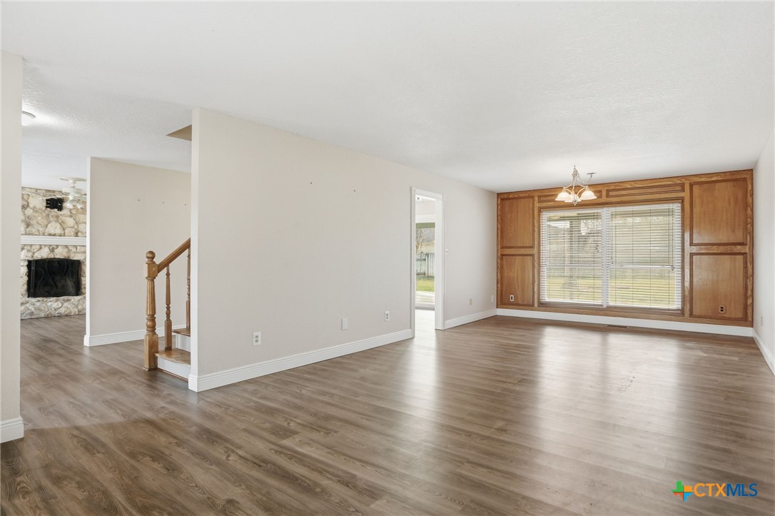119 Primrose Drive Kyle, TX 78640 - Photo 14 of 30 an empty room with wooden floor and windows