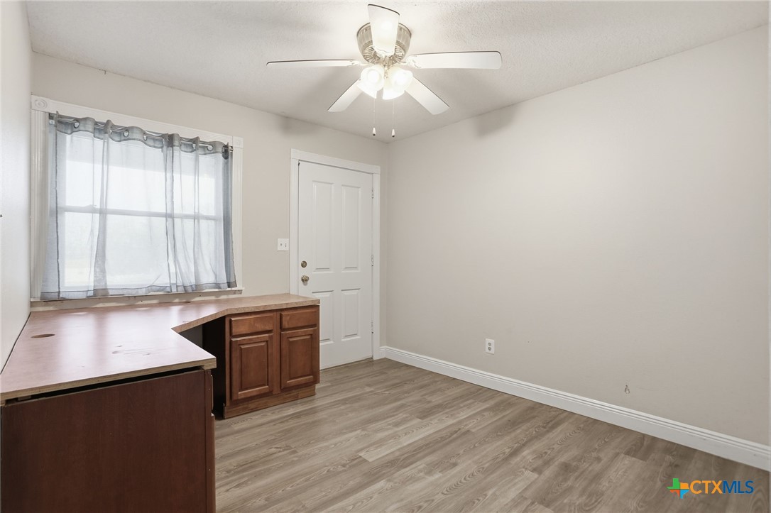 119 Primrose Drive Kyle, TX 78640 - Photo 15 of 30 wooden floor in an empty room with a window