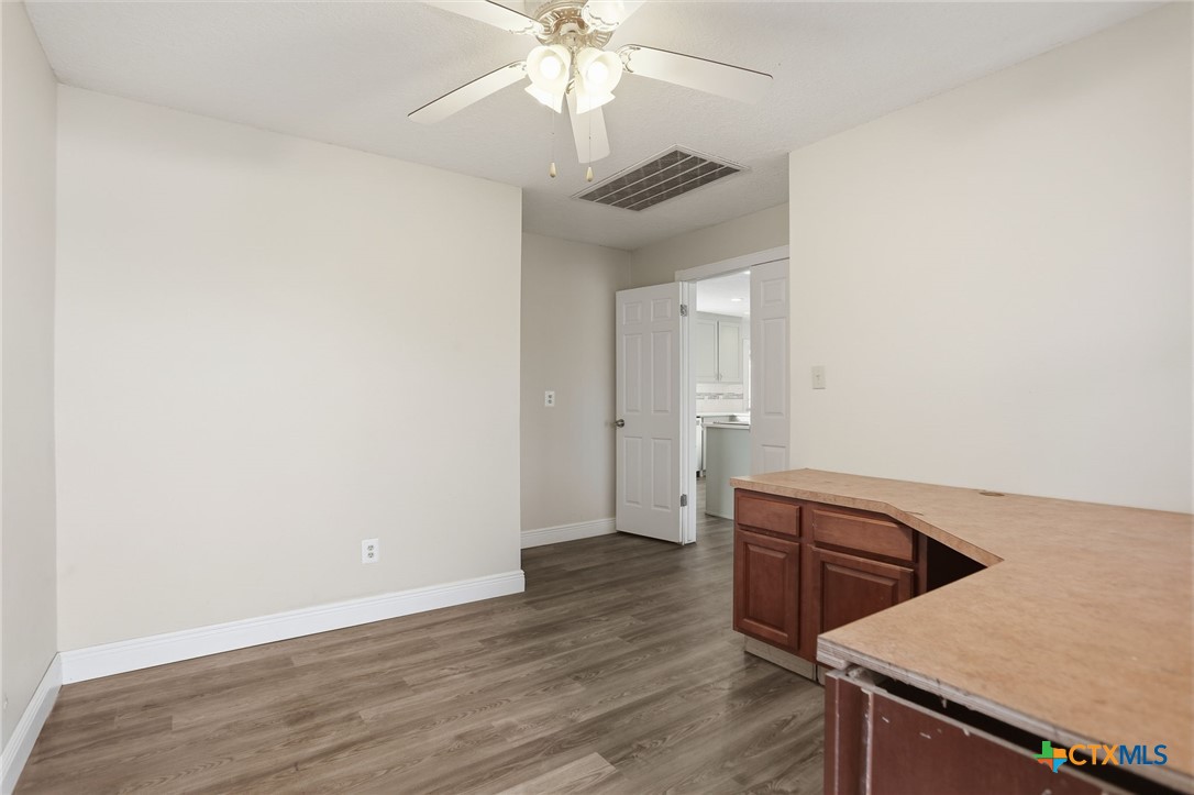 119 Primrose Drive Kyle, TX 78640 - Photo 16 of 30 an empty room with wooden floor