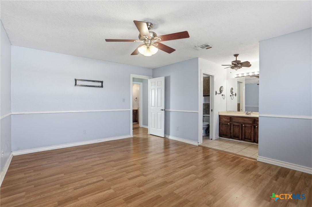 119 Primrose Drive Kyle, TX 78640 - Photo 18 of 30 a view of an empty room with a window and wooden floor