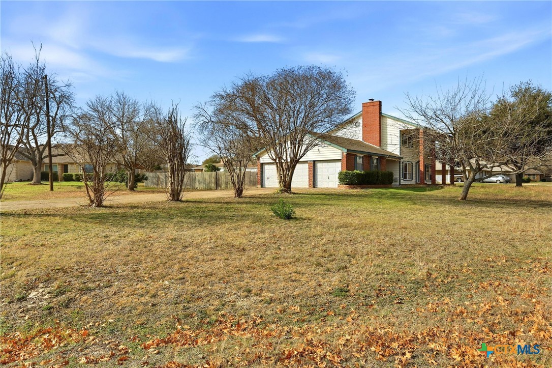 119 Primrose Drive Kyle, TX 78640 - Photo 2 of 30 a view of a yard with a house in the background