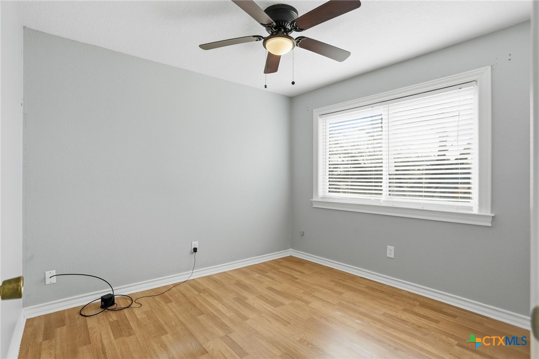 119 Primrose Drive Kyle, TX 78640 - Photo 22 of 30 a room with a window and ceiling fan