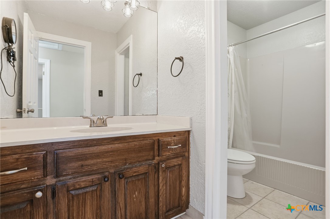 119 Primrose Drive Kyle, TX 78640 - Photo 23 of 30 a bathroom with a double vanity sink mirror and toilet