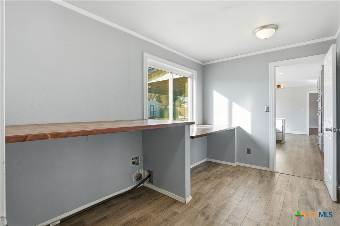 119 Primrose Drive Kyle, TX 78640 - Photo 27 of 30 a view of an empty room with wooden floor and a window