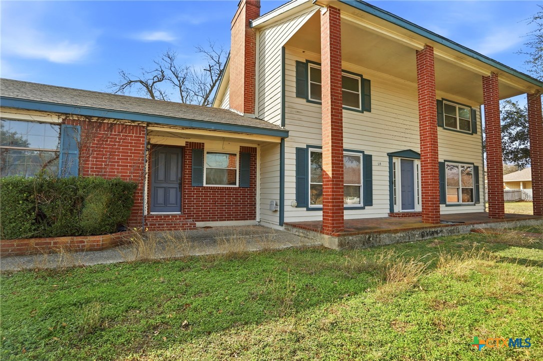 119 Primrose Drive Kyle, TX 78640 - Photo 5 of 30 a view of a house with a yard and plants