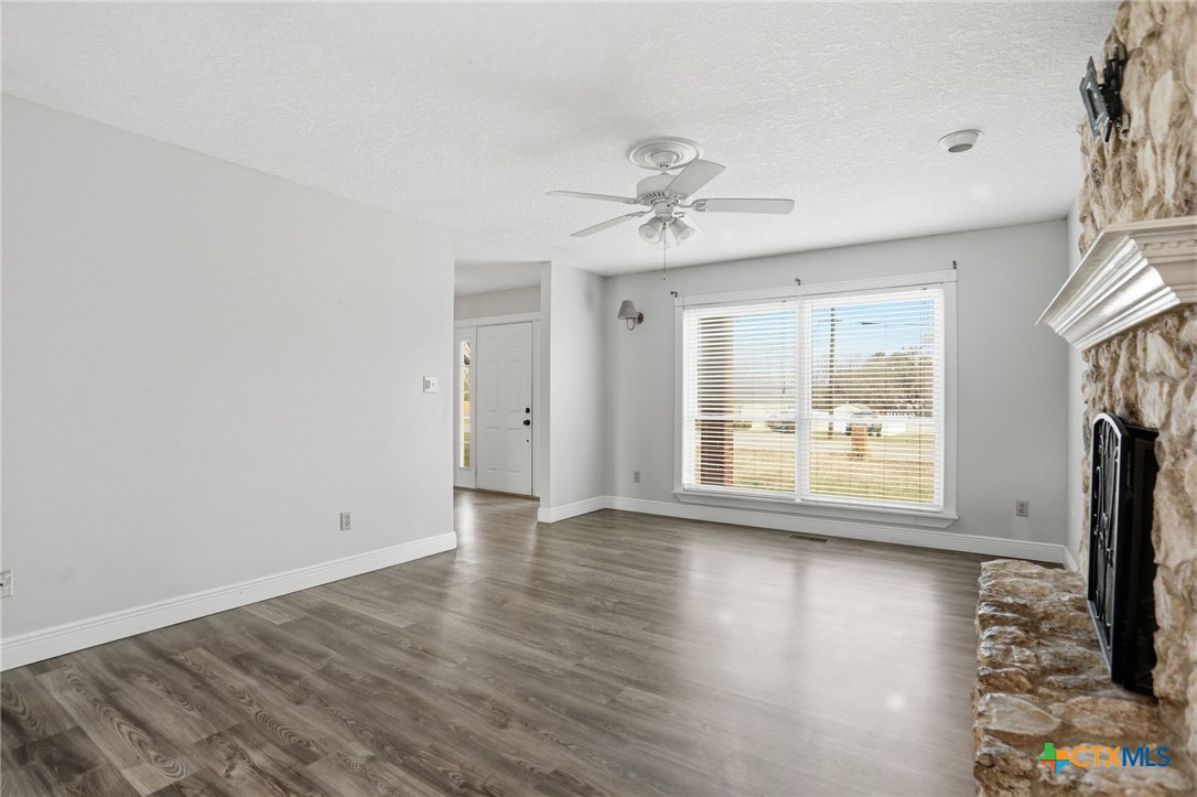 119 Primrose Drive Kyle, TX 78640 - Photo 6 of 30 a view of an empty room with a window and wooden floor