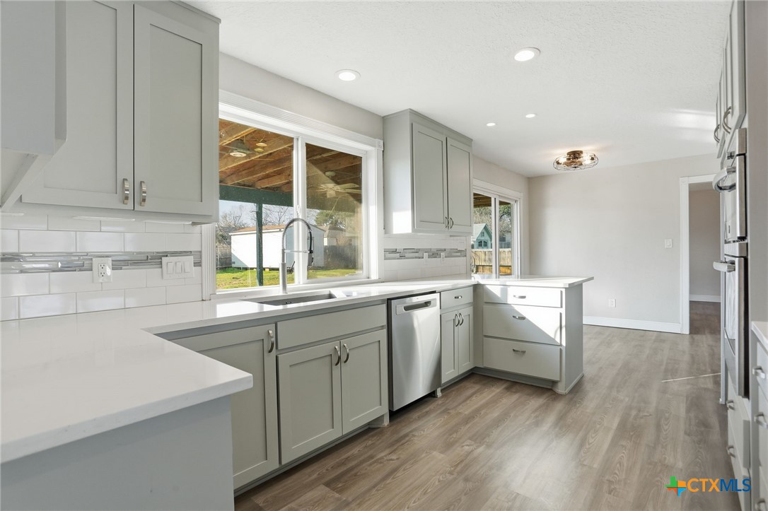 119 Primrose Drive Kyle, TX 78640 - Photo 9 of 30 a kitchen with sink cabinets and wooden floor