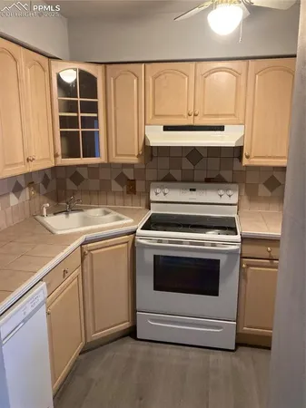 a stove top oven sitting inside of a kitchen