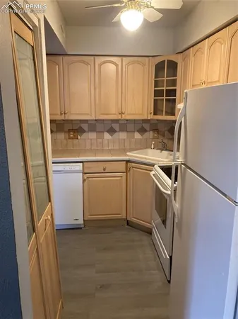 a kitchen with a sink stove and refrigerator