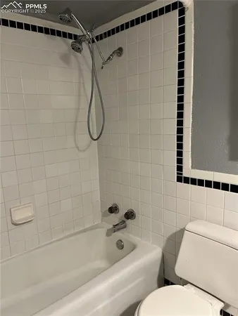 a bathroom with a toilet and shower