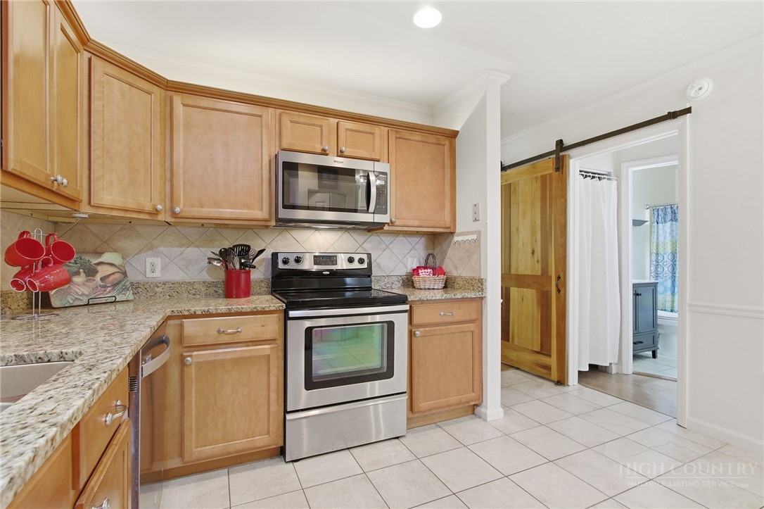 164 Rocky Meadows Road Newland, NC 28657 - Photo 11 of 49 a kitchen with granite countertop white cabinets stainless steel appliances and a counter space