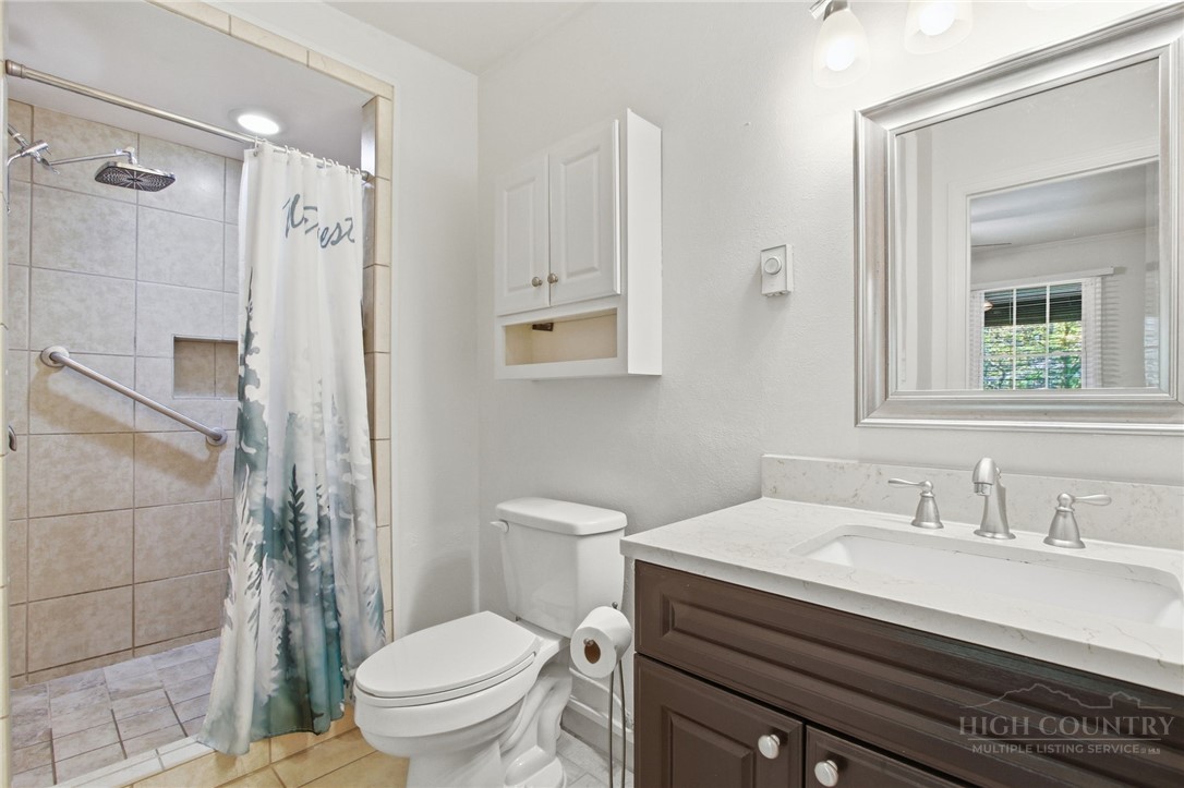 164 Rocky Meadows Road Newland, NC 28657 - Photo 15 of 49 a bathroom with a sink toilet a mirror and shower