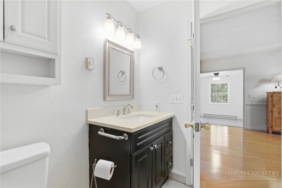 164 Rocky Meadows Road Newland, NC 28657 - Photo 16 of 49 a bathroom with a sink a toilet and mirror