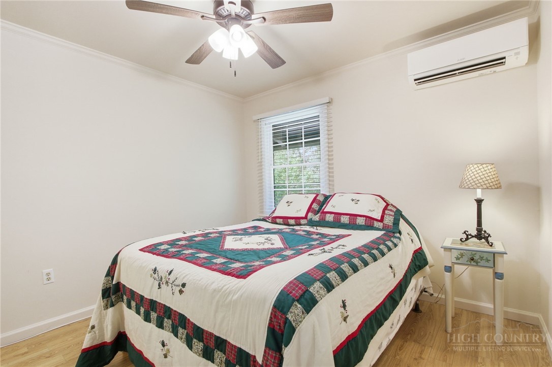 164 Rocky Meadows Road Newland, NC 28657 - Photo 18 of 49 a bedroom with a bed and a chandelier
