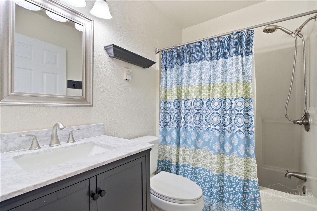 164 Rocky Meadows Road Newland, NC 28657 - Photo 25 of 49 a bathroom with a sink a toilet a shower and a mirror
