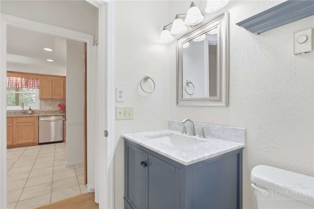 164 Rocky Meadows Road Newland, NC 28657 - Photo 26 of 49 a bathroom with a sink a toilet and a mirror