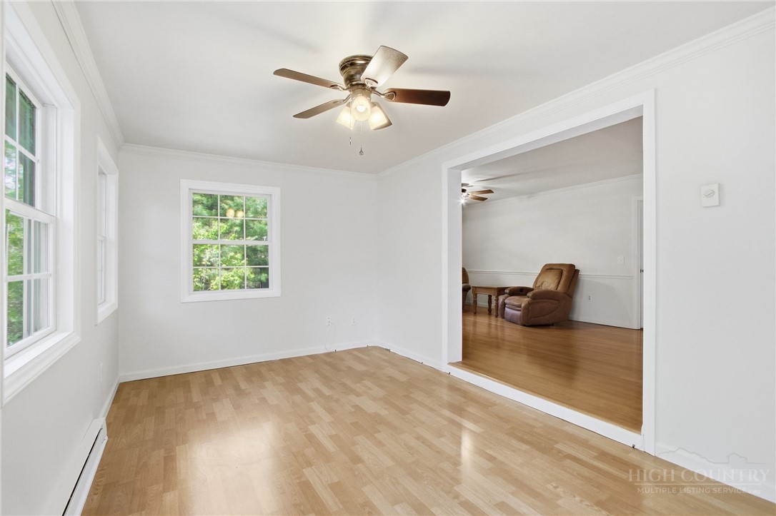 164 Rocky Meadows Road Newland, NC 28657 - Photo 31 of 49 a bedroom with a bed and a chandelier
