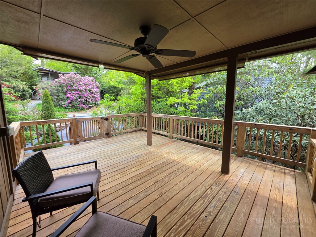 164 Rocky Meadows Road Newland, NC 28657 - Photo 32 of 49 a view of a two chairs in the deck under a umbrella