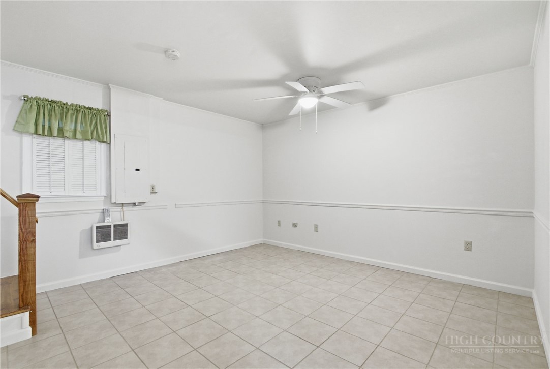 164 Rocky Meadows Road Newland, NC 28657 - Photo 36 of 49 an empty room with white walls and ceiling fan