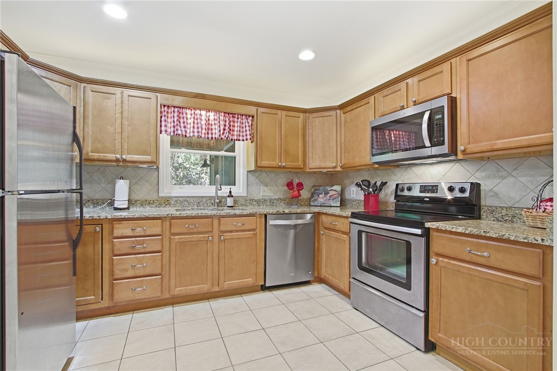 164 Rocky Meadows Road Newland, NC 28657 - Photo 8 of 49 a kitchen with stainless steel appliances granite countertop a sink and cabinets