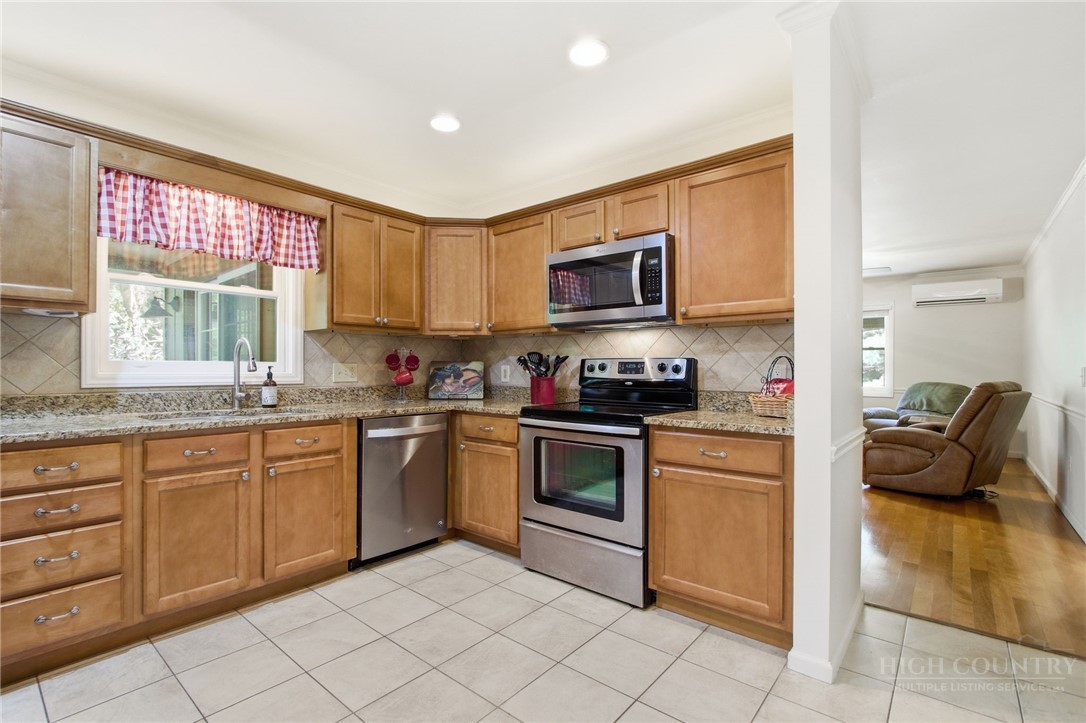 164 Rocky Meadows Road Newland, NC 28657 - Photo 9 of 49 a kitchen with a sink cabinets and window