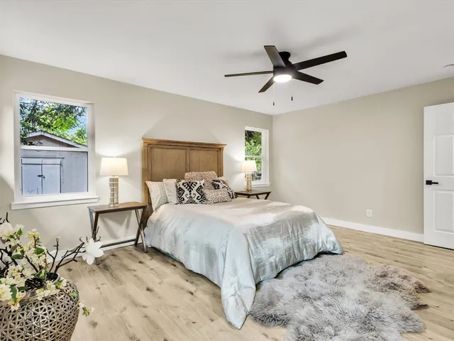 a bedroom with a bed and wooden floor