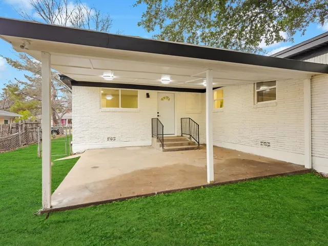 a view of a patio with table and chairs with wooden floor and fence