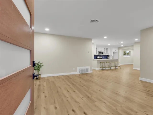 a view of a kitchen with a sink and wooden floor