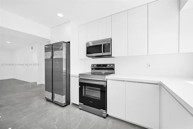 a kitchen with a refrigerator and a sink