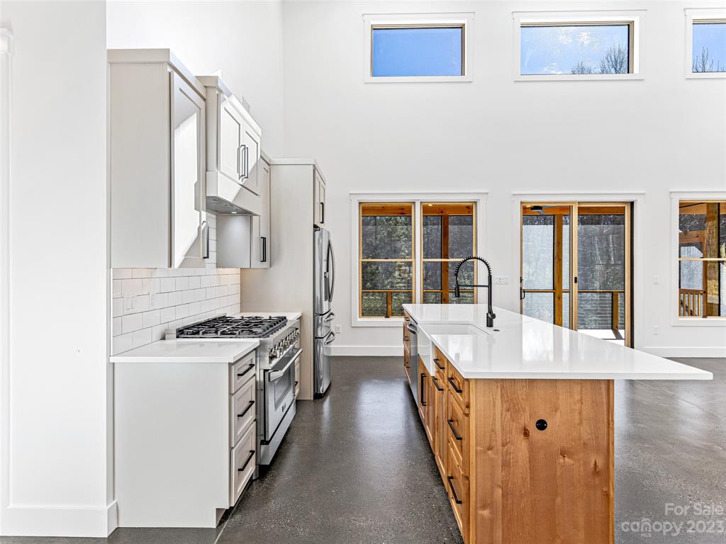 13 Small Crk Road Brevard, NC 28712 - Photo 18 of 48 a kitchen with stainless steel appliances granite countertop a stove and a white cabinets