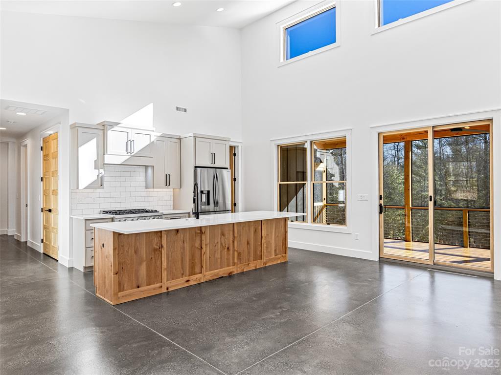 13 Small Crk Road Brevard, NC 28712 - Photo 19 of 48 a large kitchen with stainless steel appliances granite countertop a large counter top a stove and a wooden floors