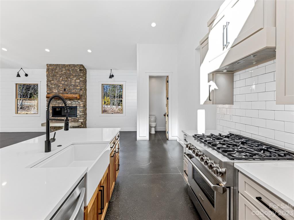 13 Small Crk Road Brevard, NC 28712 - Photo 26 of 48 a kitchen with stainless steel appliances a stove a sink and a refrigerator