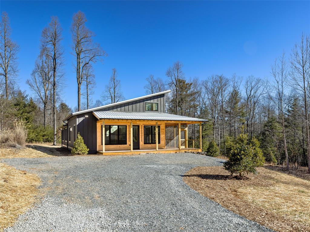 13 Small Crk Road Brevard, NC 28712 - Photo 3 of 48 a view of a house with large windows and a big yard