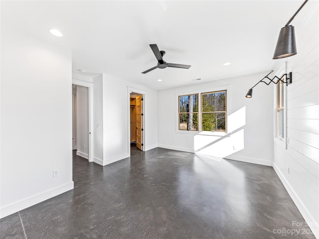 13 Small Crk Road Brevard, NC 28712 - Photo 33 of 48 a view of an empty room with a window and wooden floor